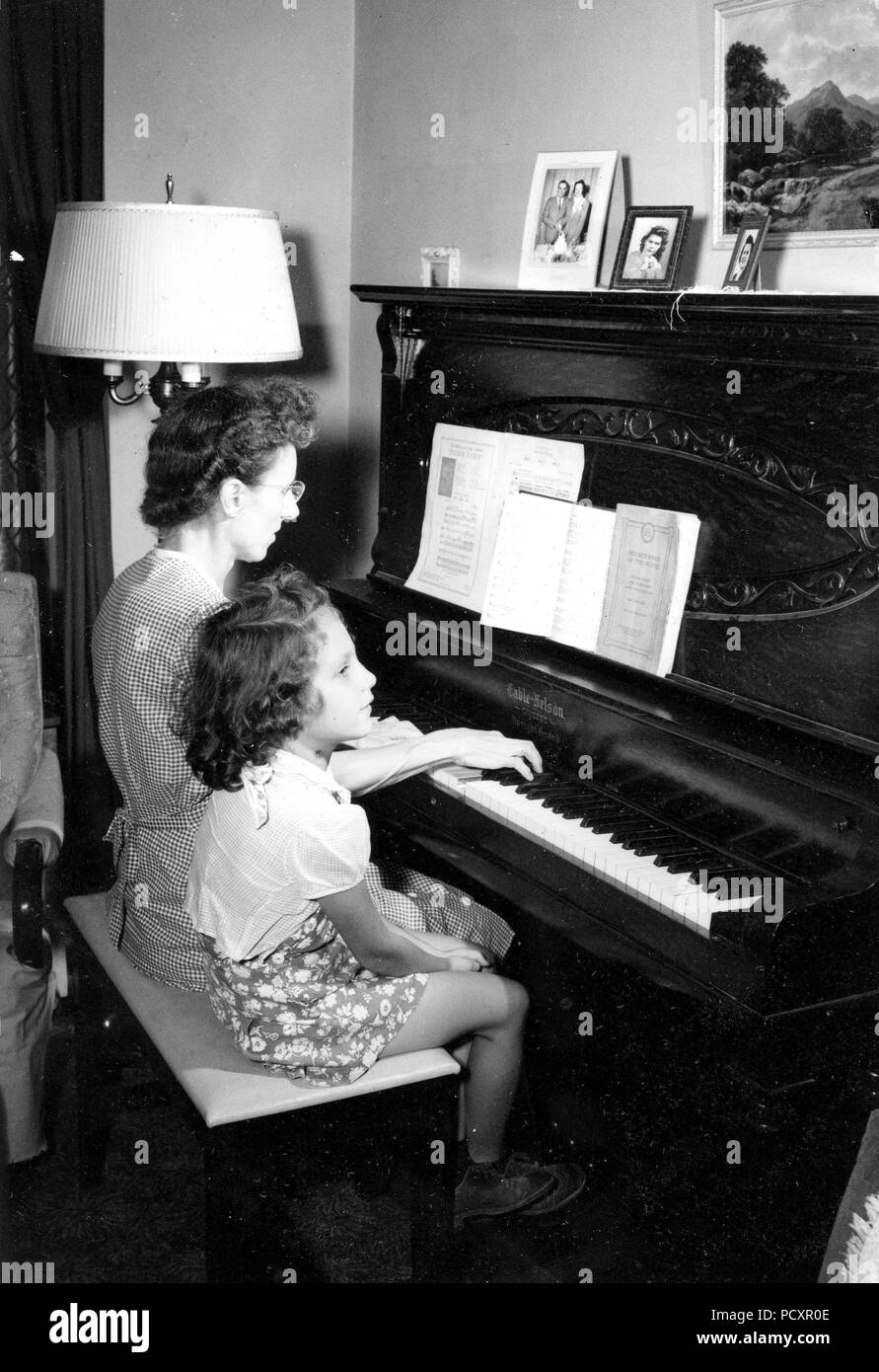 Mother playing piano 1940s hi-res stock photography and images - Alamy