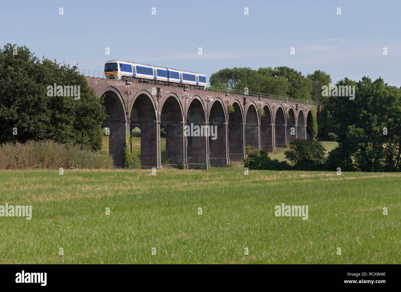 A Chiltern Railways class 165 turbo train crossing Saunderton Viaduct (south of Banbury) Stock Photo