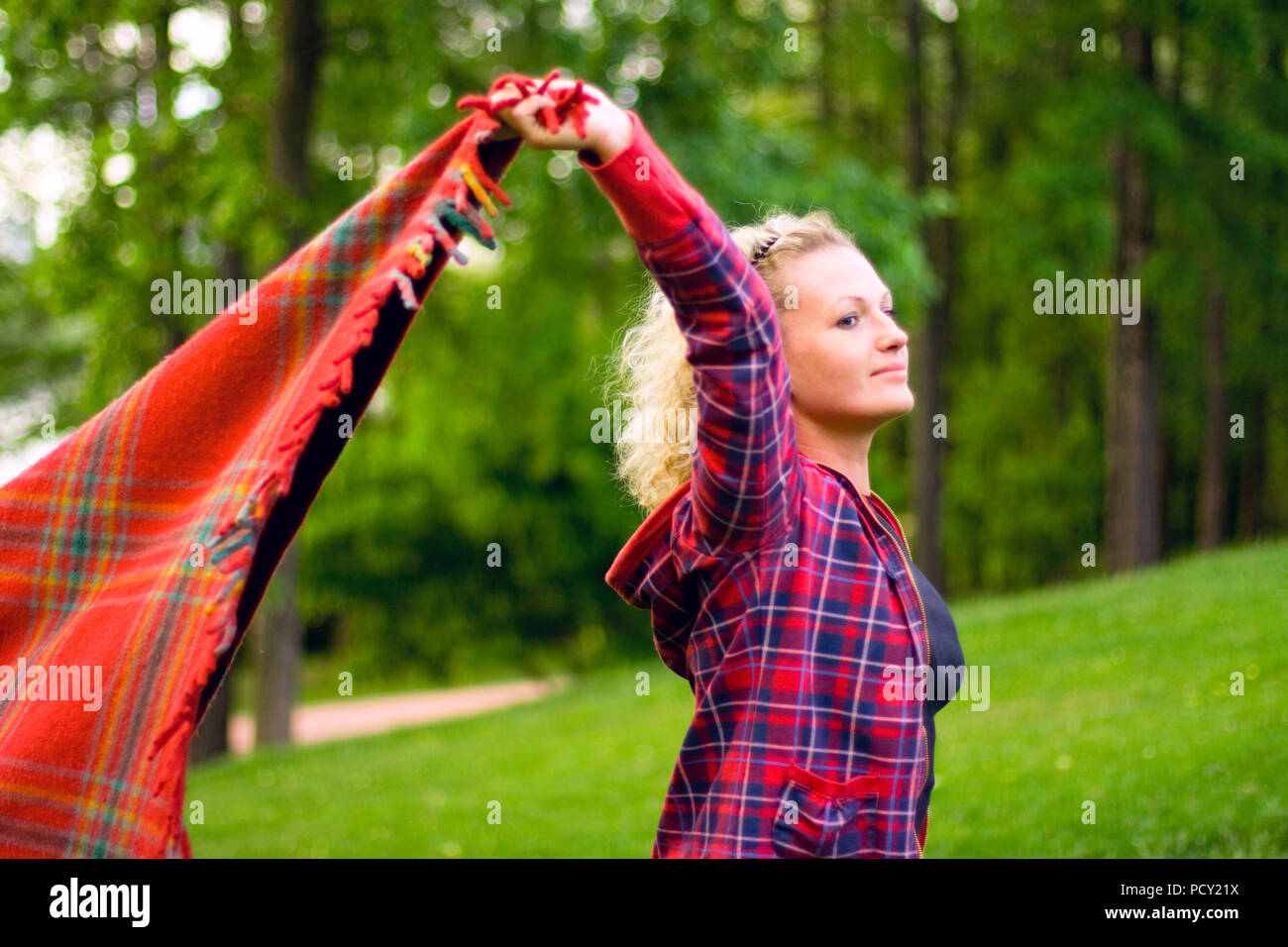 pretty woman with red coverlet in the forest Stock Photo