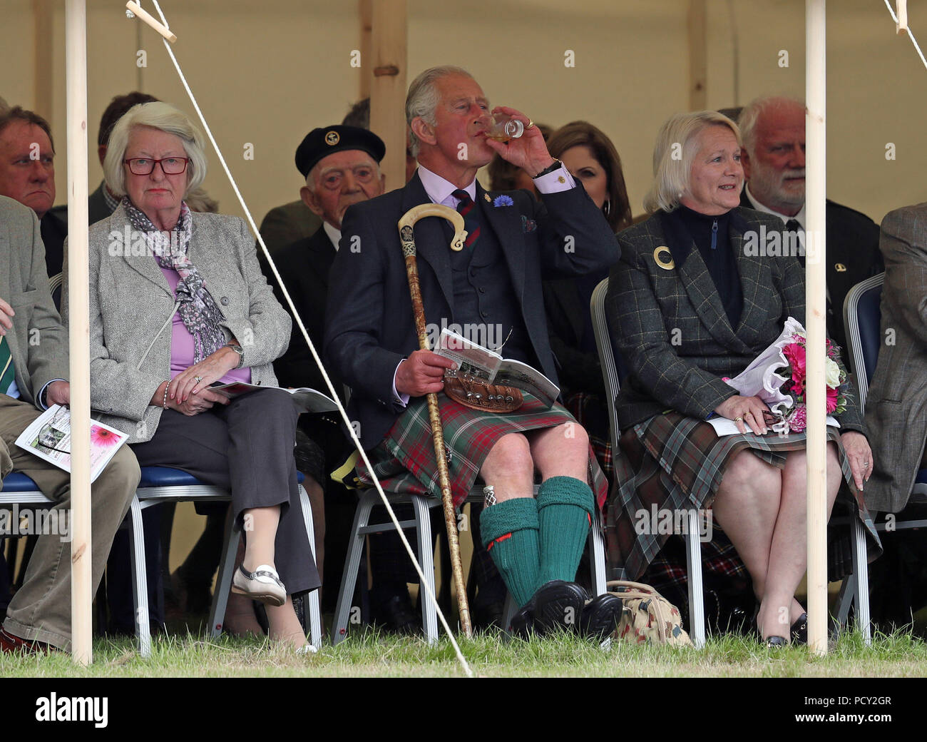 The Prince of Wales, known as the Duke of Rothesay in Scotland, has a dram as he attends the Mey Highland & Cultural Games at the John O'Groats Showground in Caithness. Stock Photo