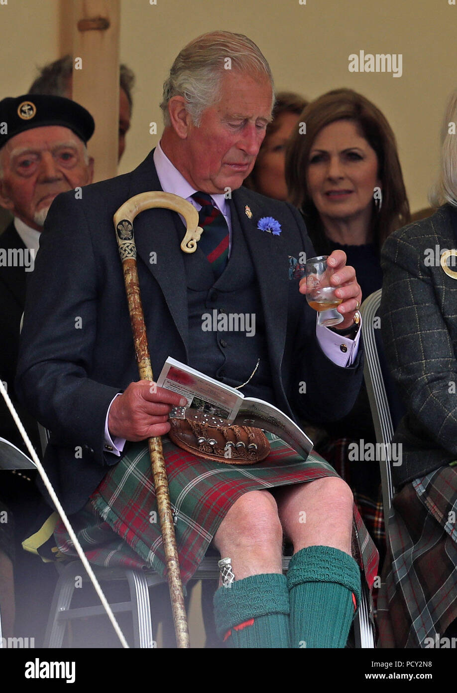 The Prince of Wales, known as the Duke of Rothesay in Scotland, has a dram as he attends the Mey Highland & Cultural Games at the John O'Groats Showground in Caithness. Stock Photo