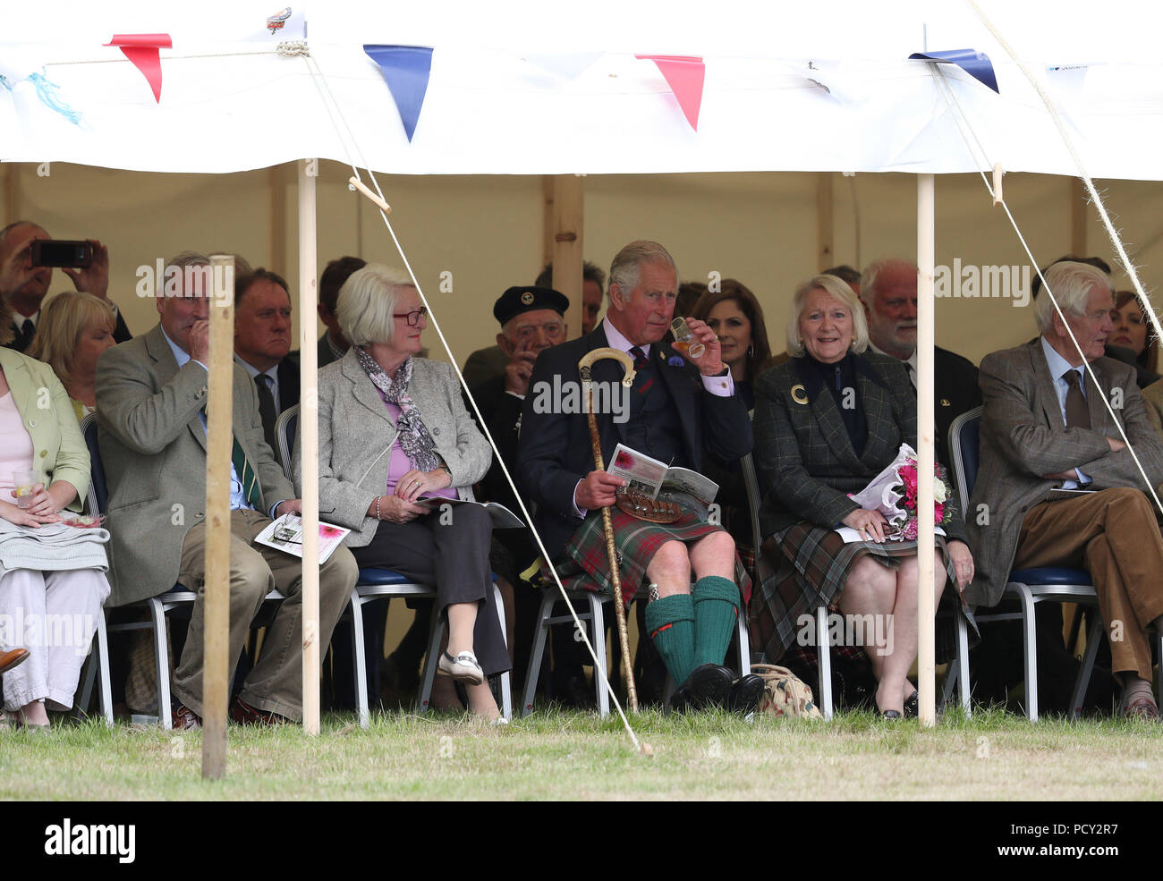 The Prince of Wales, known as the Duke of Rothesay in Scotland, has a dram as he attends the Mey Highland & Cultural Games at the John O'Groats Showground in Caithness. Stock Photo