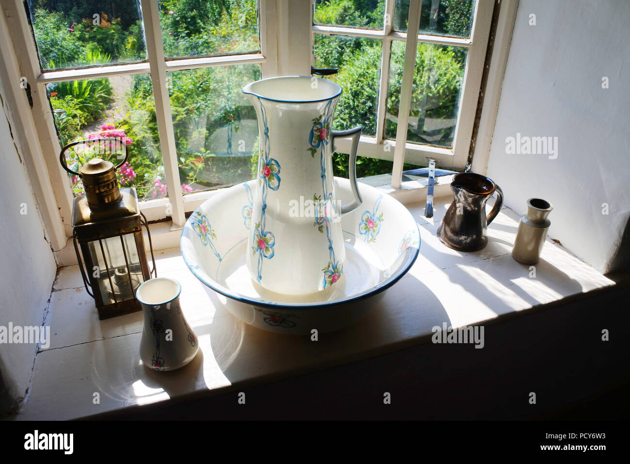 Washing jug and bowl on a Victorian window sill - John Gollop Stock Photo