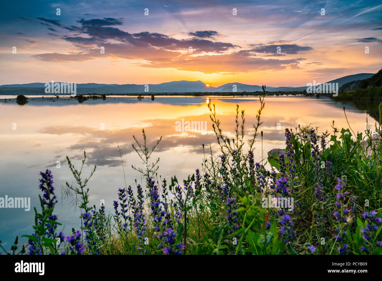Sunset on the lake with colorful clouds, Lika Croatia Stock Photo