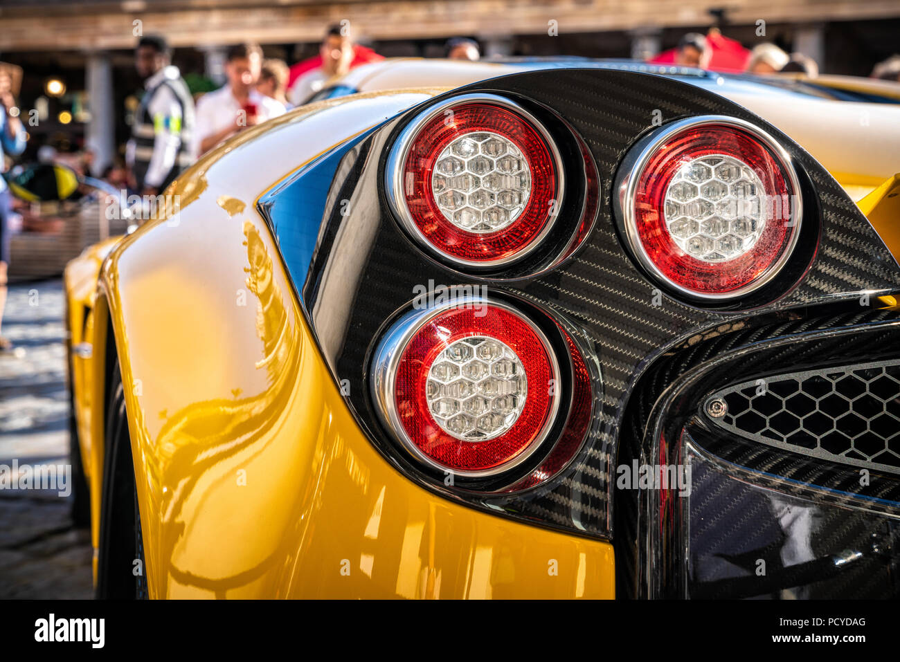Modern design circular rear brake lights of the yellow supercar. Stock Photo