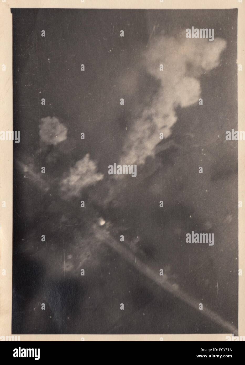 Image from the photo album of Oberfeldwebel Gotthilf Benseler of 9. Staffel, Kampfgeschwader 3: The view from a German aircraft as bombs dropped by the Dornier Do17Z-2s of 9. Staffel, Kampfgeschwader 3 explode across a French Road during the Battle of France in May 1940. Stock Photo