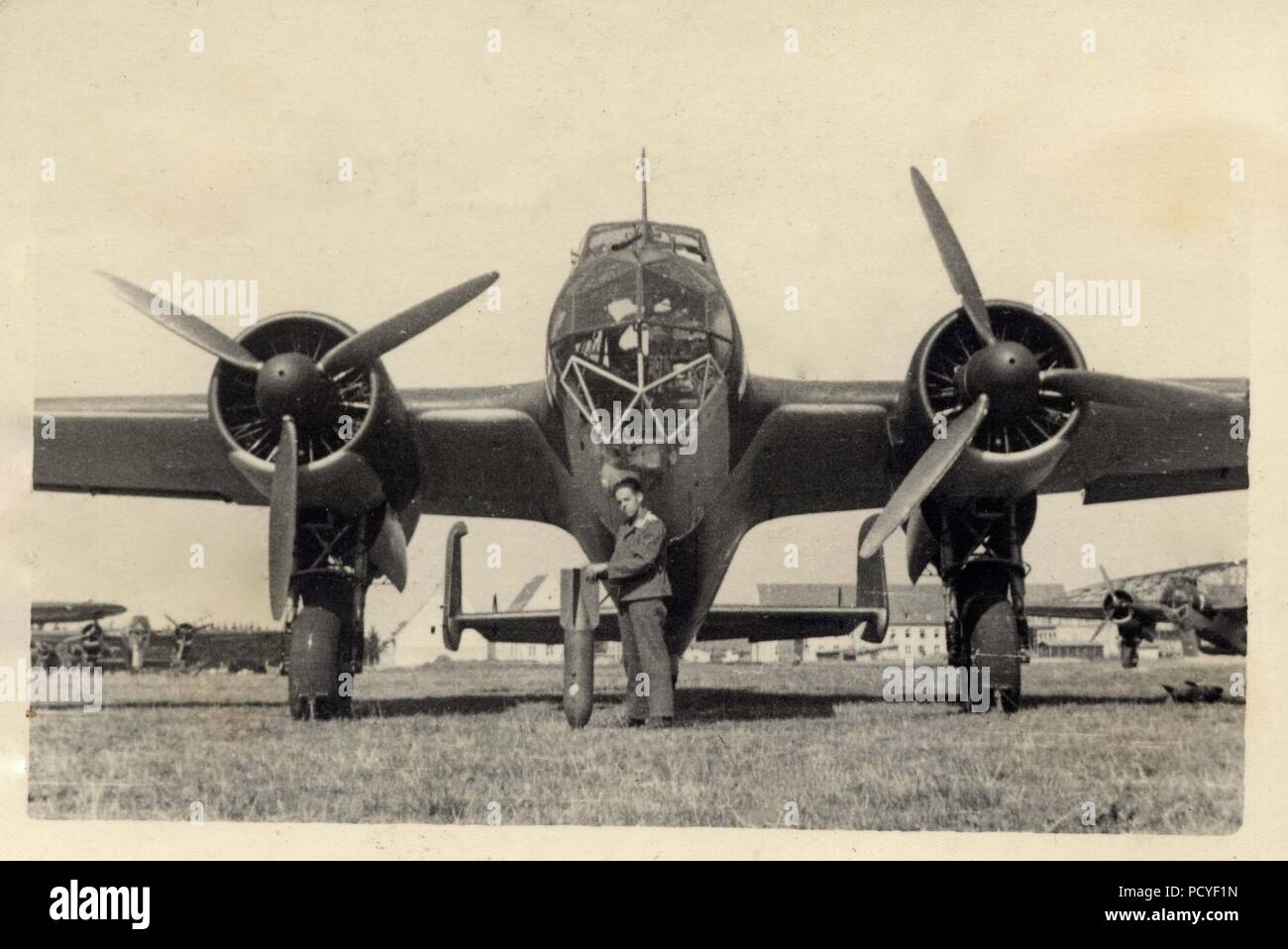 Image from the photo album of Oberfeldwebel Gotthilf Benseler of 9. Staffel, Kampfgeschwader 3: A Luftwaffe airman of 9./KG 3 poses with a bomb in front of one of the unit's Dornier Do 17Z-2s during the Poland Campaign, September 1939. Stock Photo