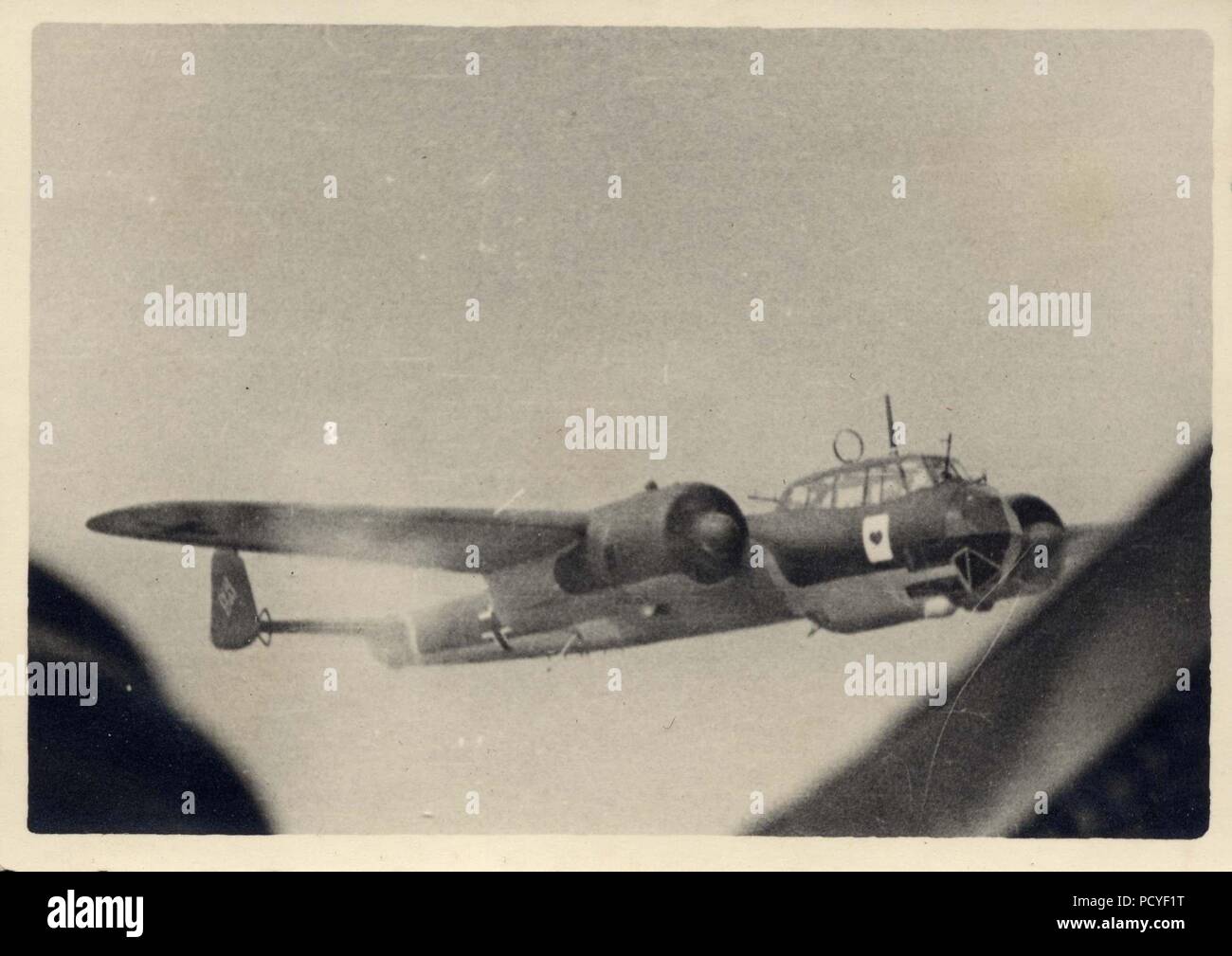 Image from the photo album of Oberfeldwebel Gotthilf Benseler of 9. Staffel, Kampfgeschwader 3: Dornier Do17Z-2s of 9. Staffel, Kampfgeschwader 3 in formation in 1939. The aircraft in this image carries the early 'Ace of Hearts' Staffel badge, inherited from the unit's predecessor 9./KG 153. In later versions, the Staffel badge showed only the red heart and the large, white playing card was omitted. The aircraft are armed with machine-guns, which may indicate that this image was taken early in the campaign against Poland in 1939. Stock Photo