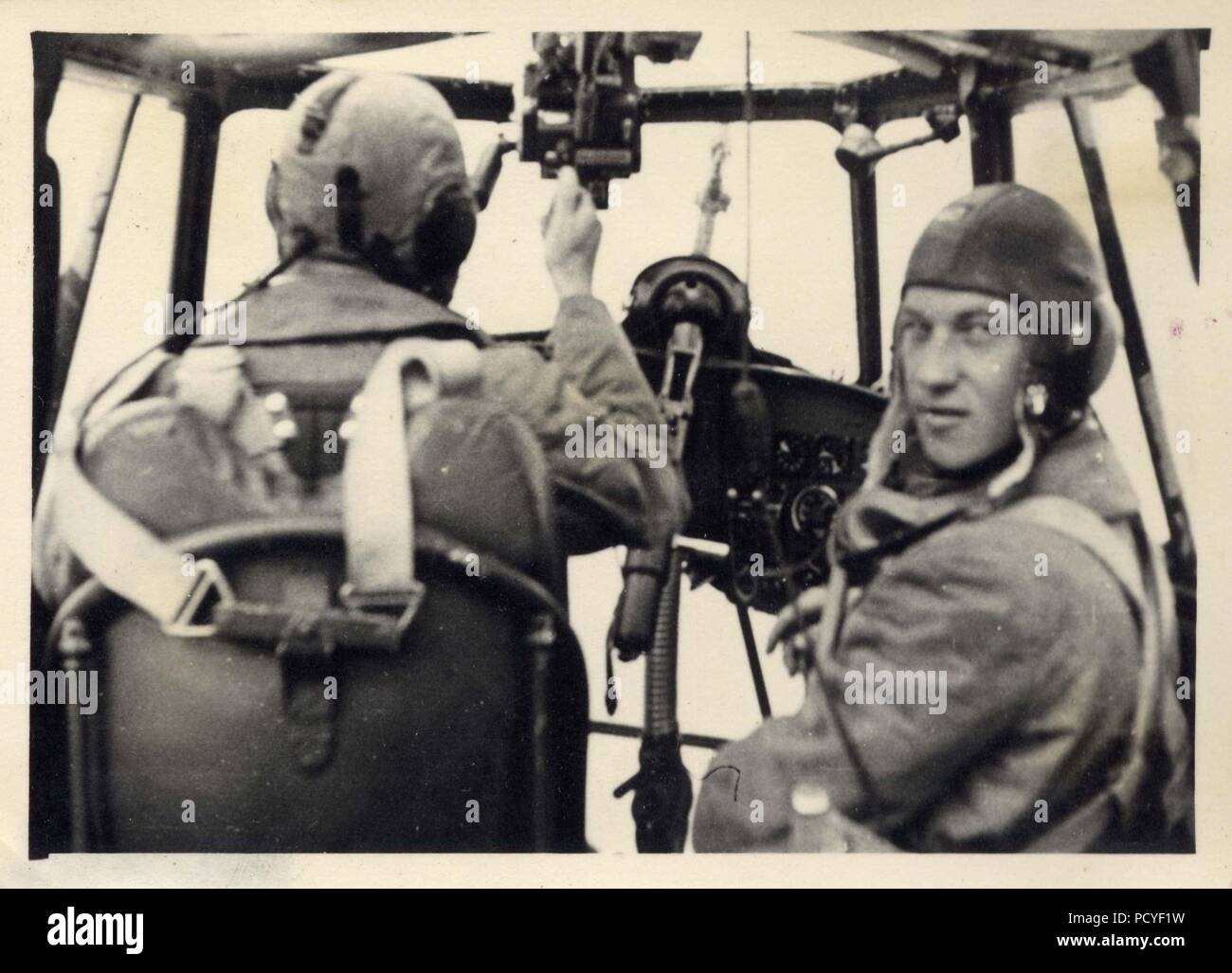 Image from the photo album of Oberfeldwebel Gotthilf Benseler of 9. Staffel, Kampfgeschwader 3: The Observer in a Dornier Do 17Z of 9./KG 3 turns towards the camera as his Pilot adjusts his controls. The MG 15 machine-gun used by the Pilot in action is in position for their mission. Poland, September 1939. Stock Photo
