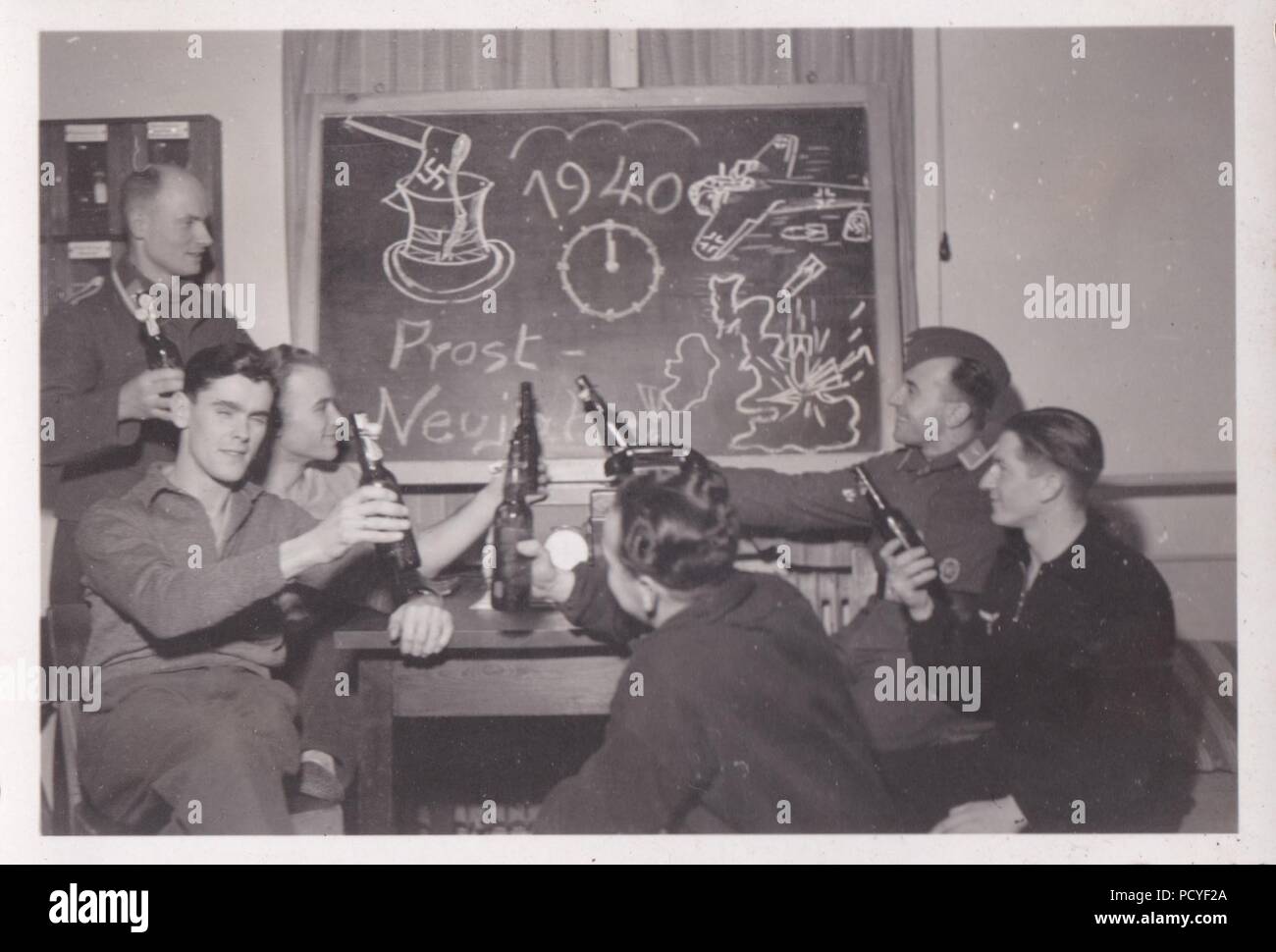 Image from the photo album of Oberfeldwebel Gotthilf Benseler of 9. Staffel, Kampfgeschwader 3: Unteroffizier Gotthilf Benseler (rear right) celebrates New Year 1940 with fellow airmen of 9./KG 3. Stock Photo