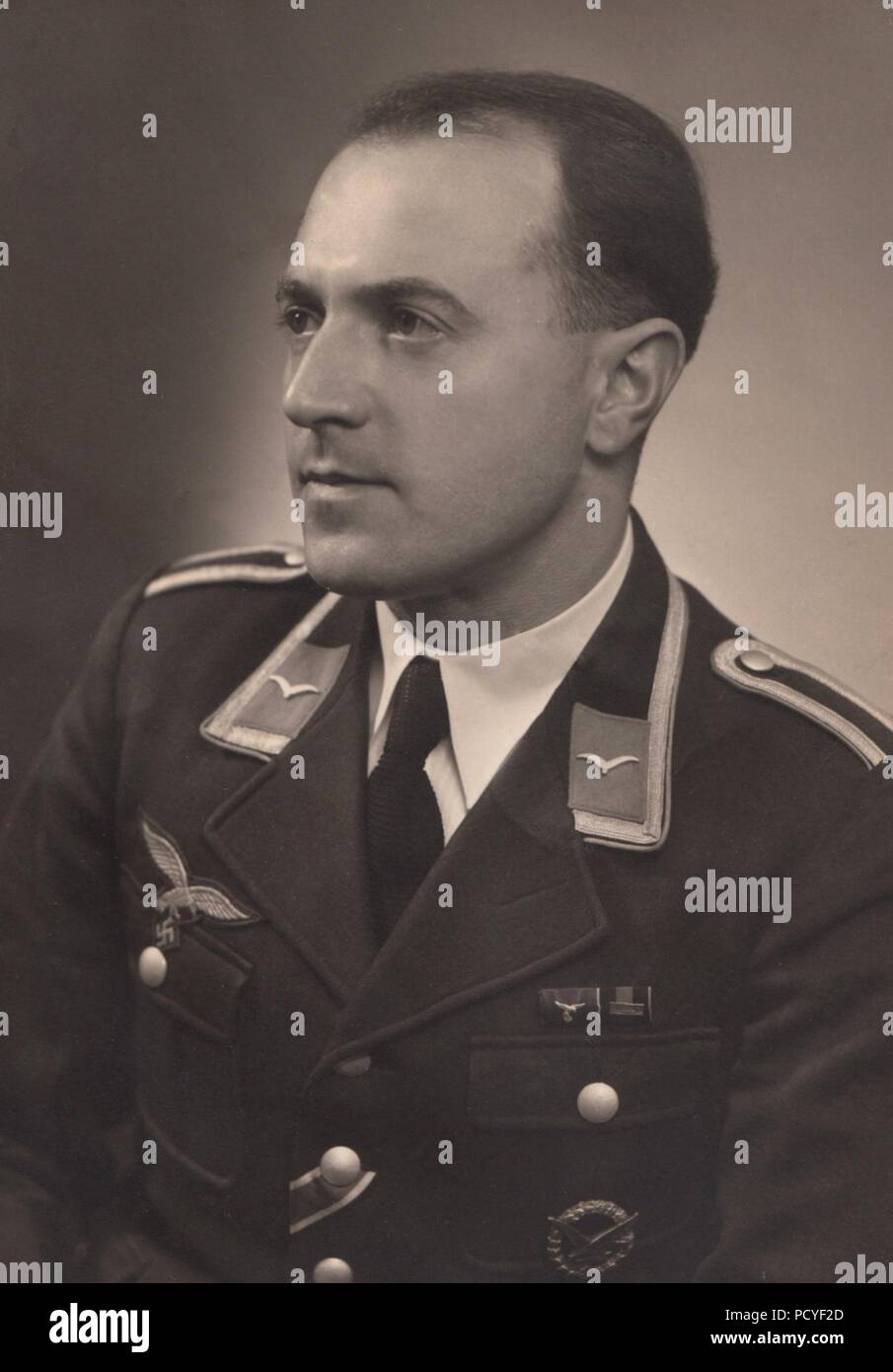 Image from the photo album of Oberfeldwebel Gotthilf Benseler of 9. Staffel, Kampfgeschwader 3: Portrait of Gotthilf Benseler as an Unteroffizier, showing him wearing the Luftwaffe Radio Operator/Air Gunner Award Badge and medal bar with ribbons for Long Service Medal IV Class and Commemorative Medal for the 1st October 1938  with Prague Castle Bar. Stock Photo