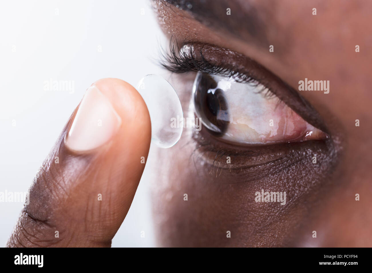 A Person's Finger Putting Contact Lens In Eye Stock Photo Alamy