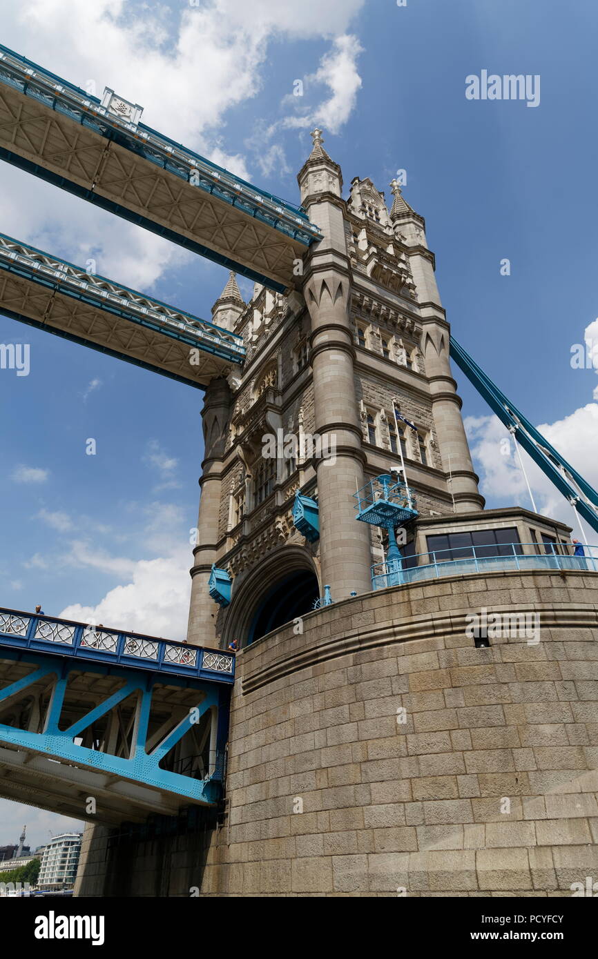 Looking up to one of the spires of Tower Bridge from a Thames tour boat River Thames London Stock Photo
