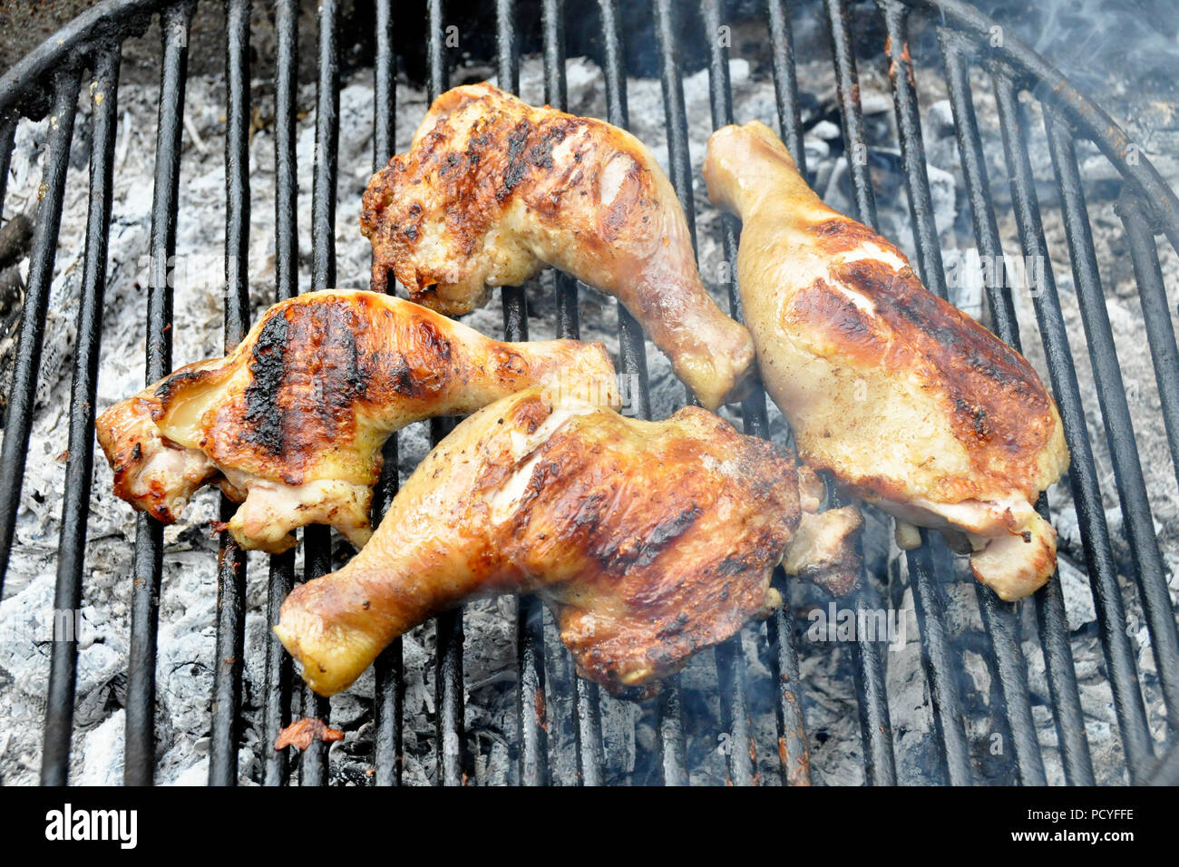 Grilled chicken thigh on the flaming grill Stock Photo Alamy