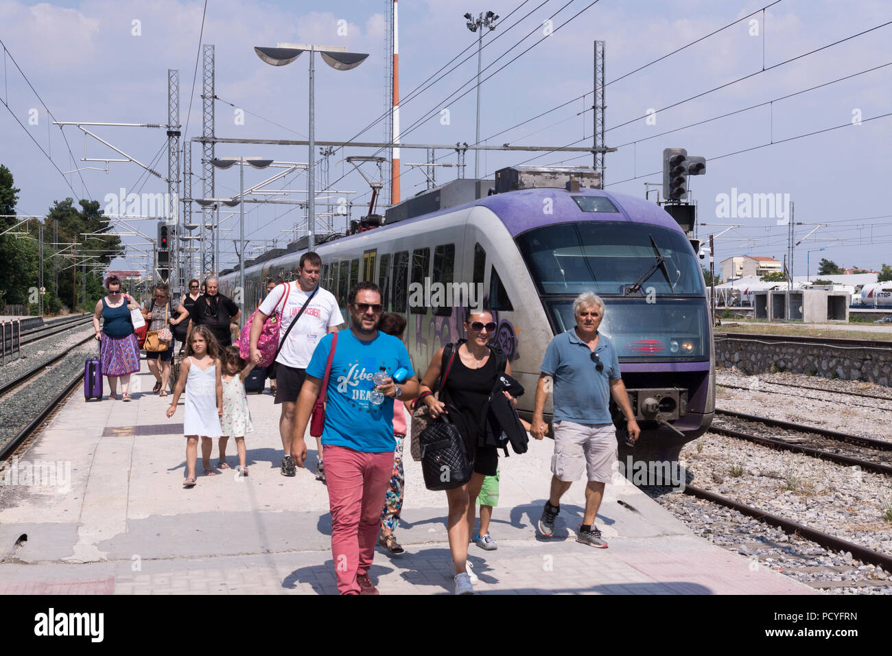 Passengers disembarking from a train at Larisa train station, Greece Stock Photo
