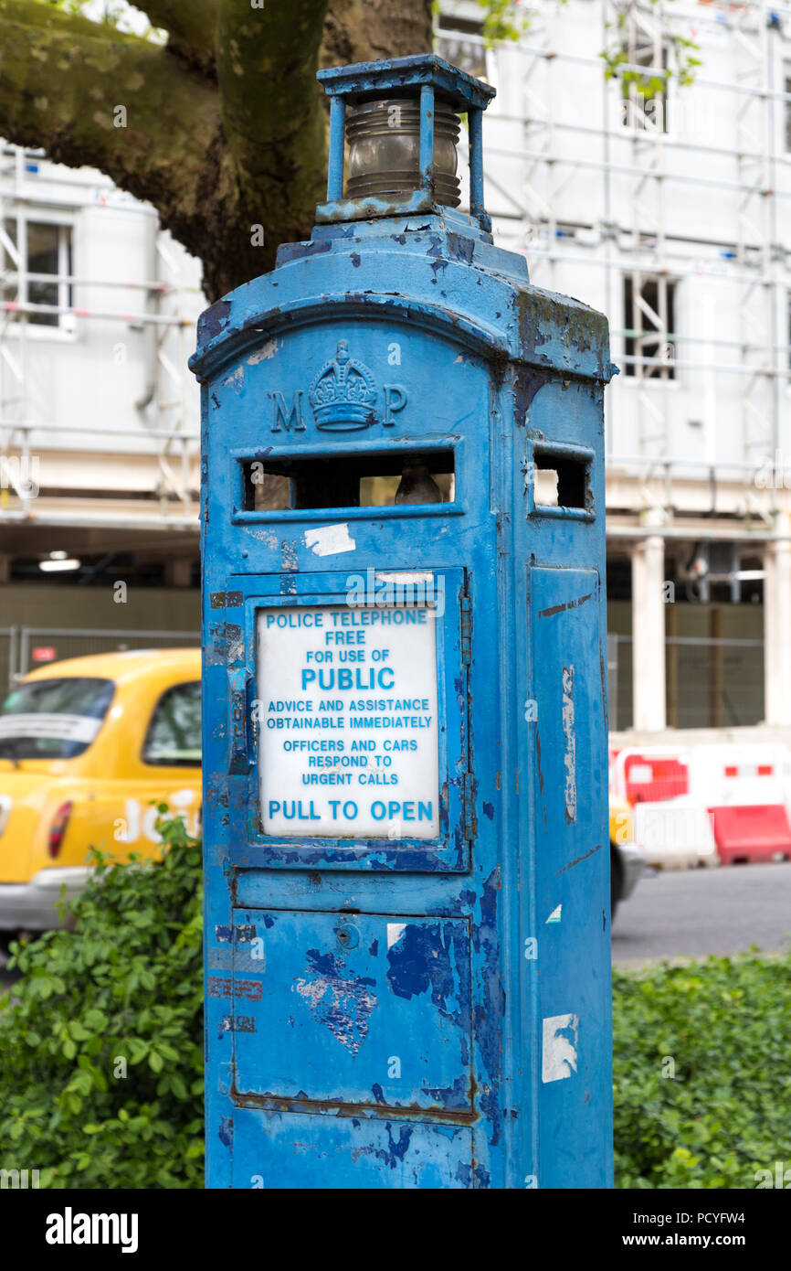 A blue police pillar telephone box for public use, London, UK Stock Photo