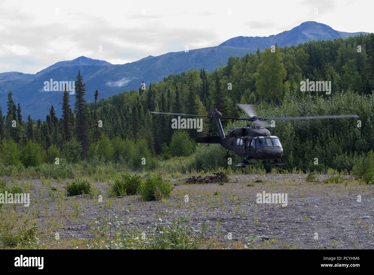 Marines with 3rd Battalion, 23rd Marine Regiment, competing in the 4th Marine Division Annual Rifle Squad Competition, provide security after getting dropped off by a U.S. Army Sikorsky UH-60 Black Hawk at Joint Base Elmendorf-Richardson, Anchorage, Alaska, August 3, 2018. Super Squad Competitions were designed to evaluate a 14-man infantry squad throughout an extensive field and live-fire evolution. (U.S. Marine Corps photo by Lance Cpl. Samantha Schwoch/released) Stock Photo