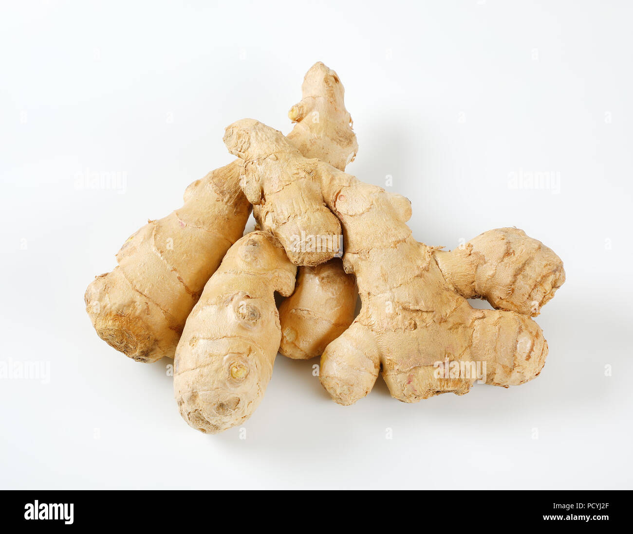fresh ginger roots on white background Stock Photo - Alamy