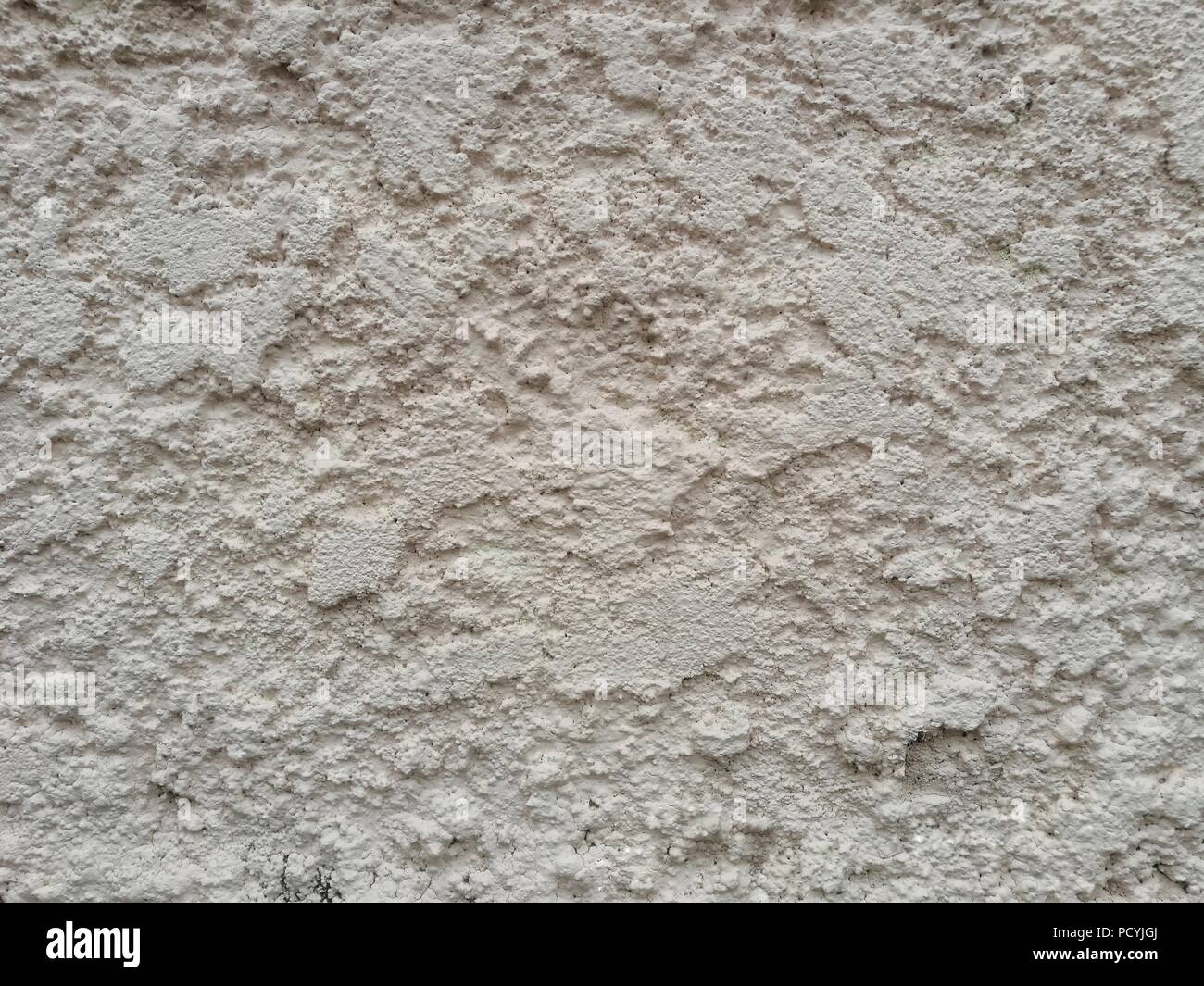 rough stucco cover clad on masonry brick wall. light pink colour rough old concrete wall. Stock Photo