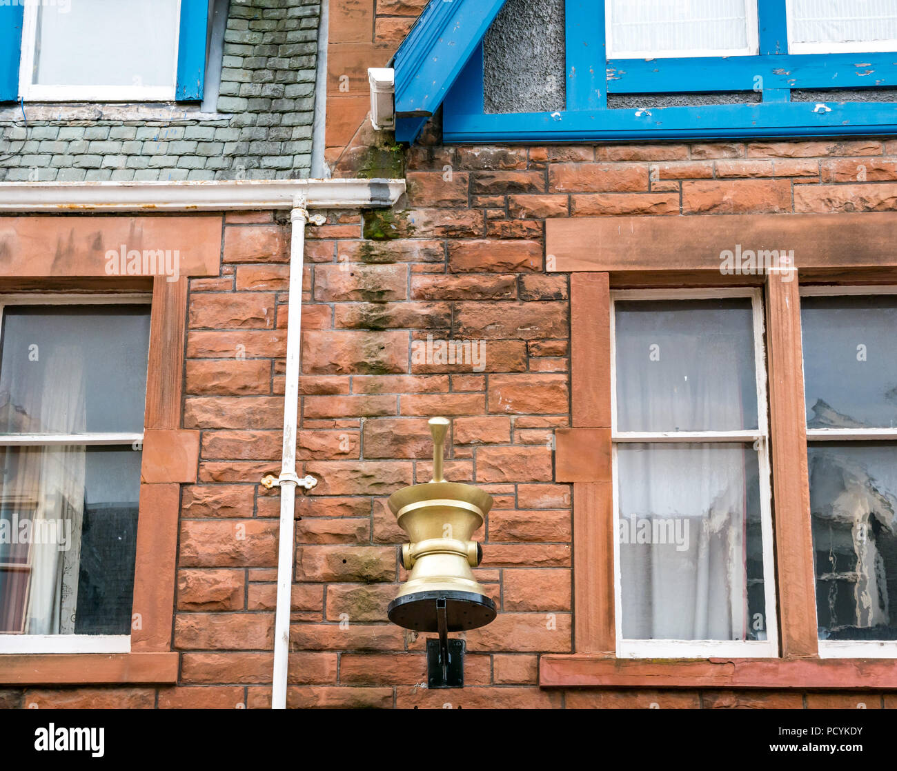 Old apothecary mortar and pestle symbol sign above Boots pharmacy, High