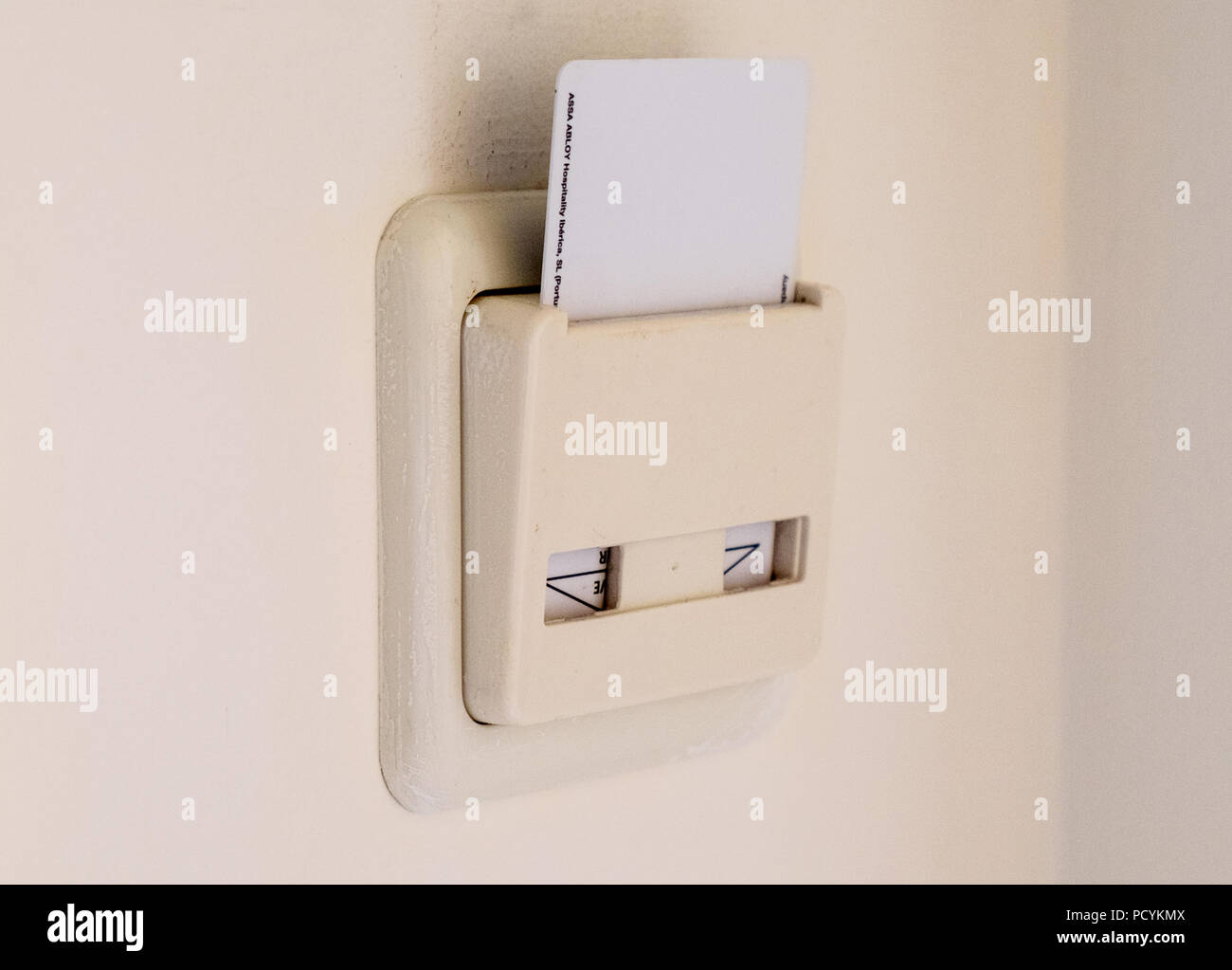 Hotel key card placed into a room switch to turn on the power Stock Photo