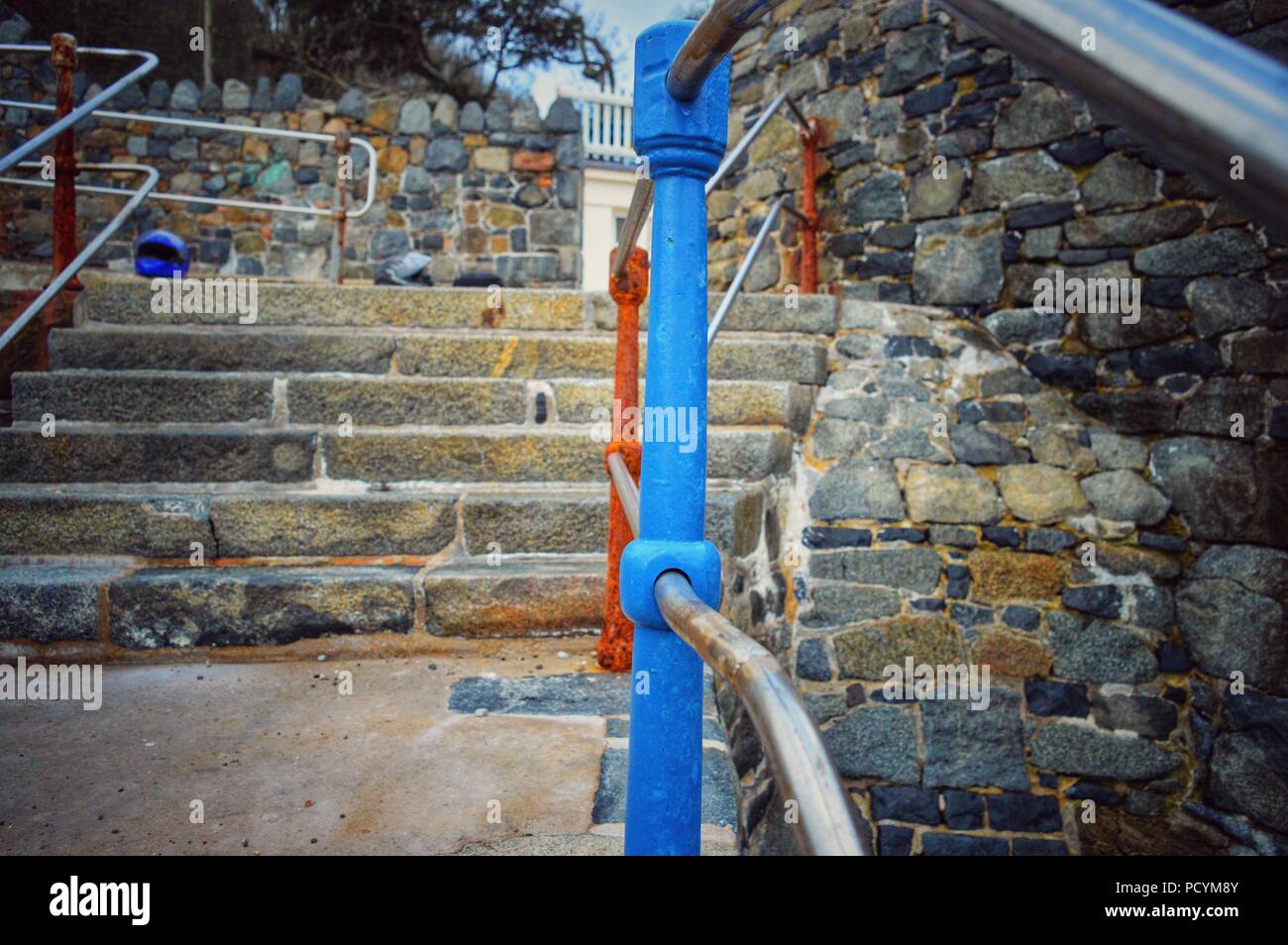 A photo of a rusting railing leading away from the beach, highlighting ...