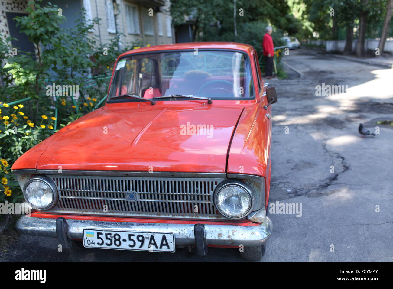 Soviet rear-drive GT class orange Moskvich-412, a partnership w/BMW in 1967-75, 3rd at World Cup rally London-Mexico,1970, parked near house in Dnepr Stock Photo