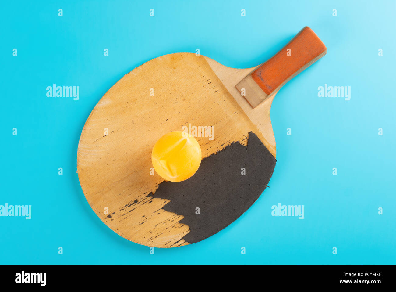 pingpong racket and a ball on blue background Stock Photo