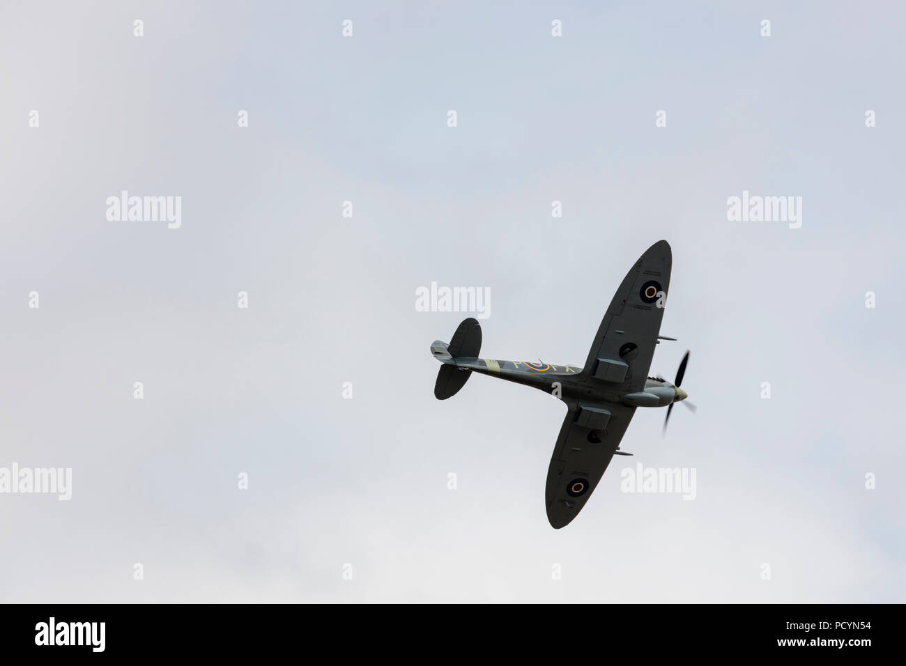 Underside view of a historic RAF Spitfire aeroplane in flight Stock Photo