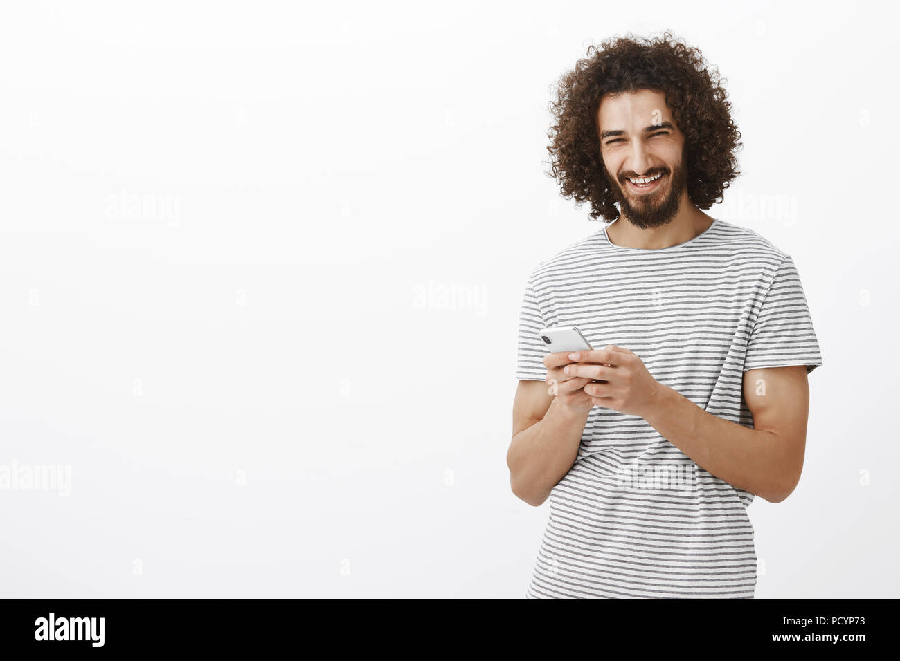 Happy Carefree Good Looking Guy With Beard And Afro Haircut