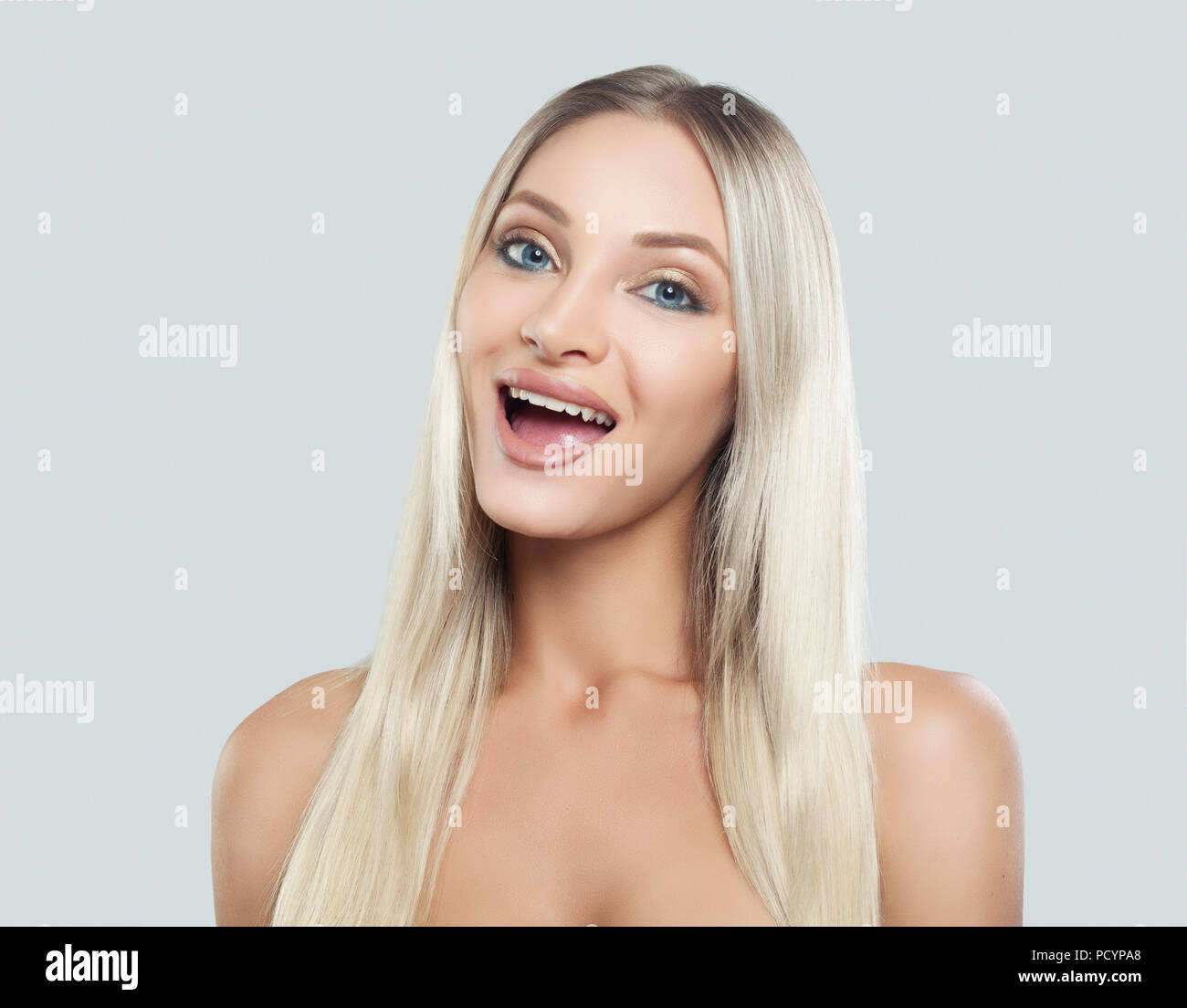 Beautiful Surprised Woman With Clean Fresh Skin Natural Makeup Blonde Hair And Opened Mouth On White Background Presenting Your Product Expressive Stock Photo Alamy