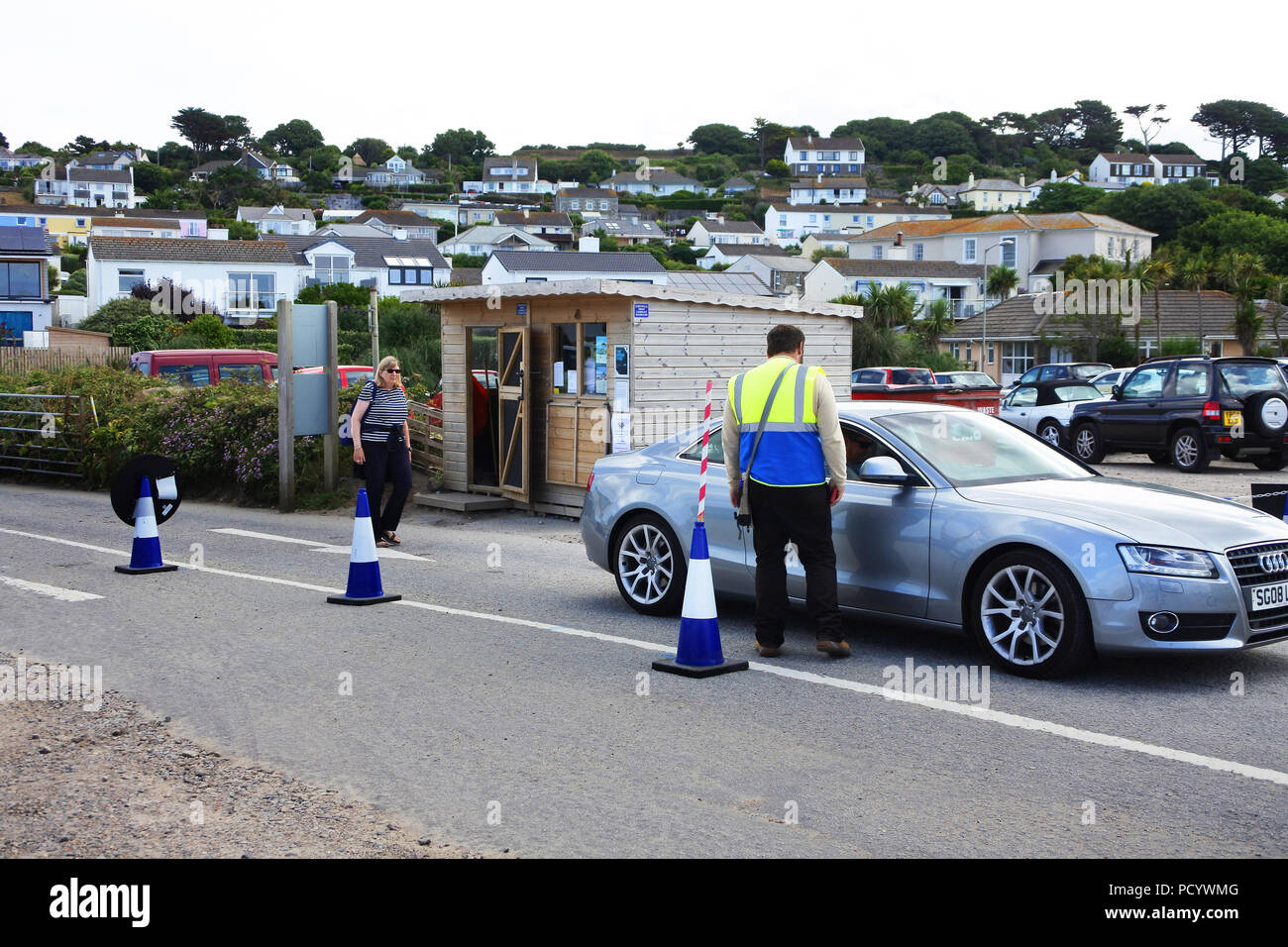 Car parkers collecting money at the entrance to the main St. Michael's Mount car park, Marazion, Cornwall, UK - John Gollop Stock Photo