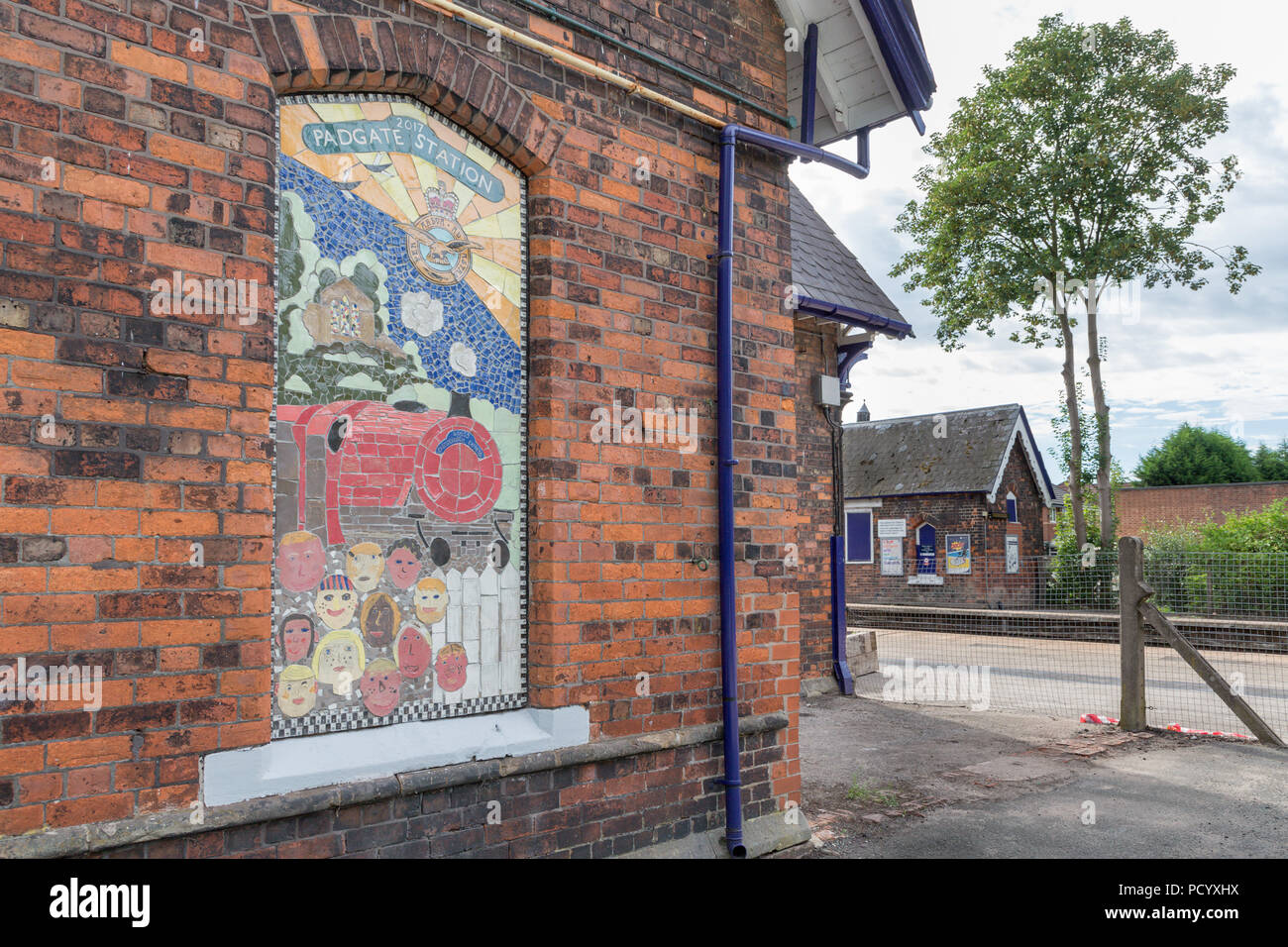 A no longer used window has been decoratively pictured with a mosaic of The Christchurch Express train at the Historic Railway Station of Padgate, War Stock Photo