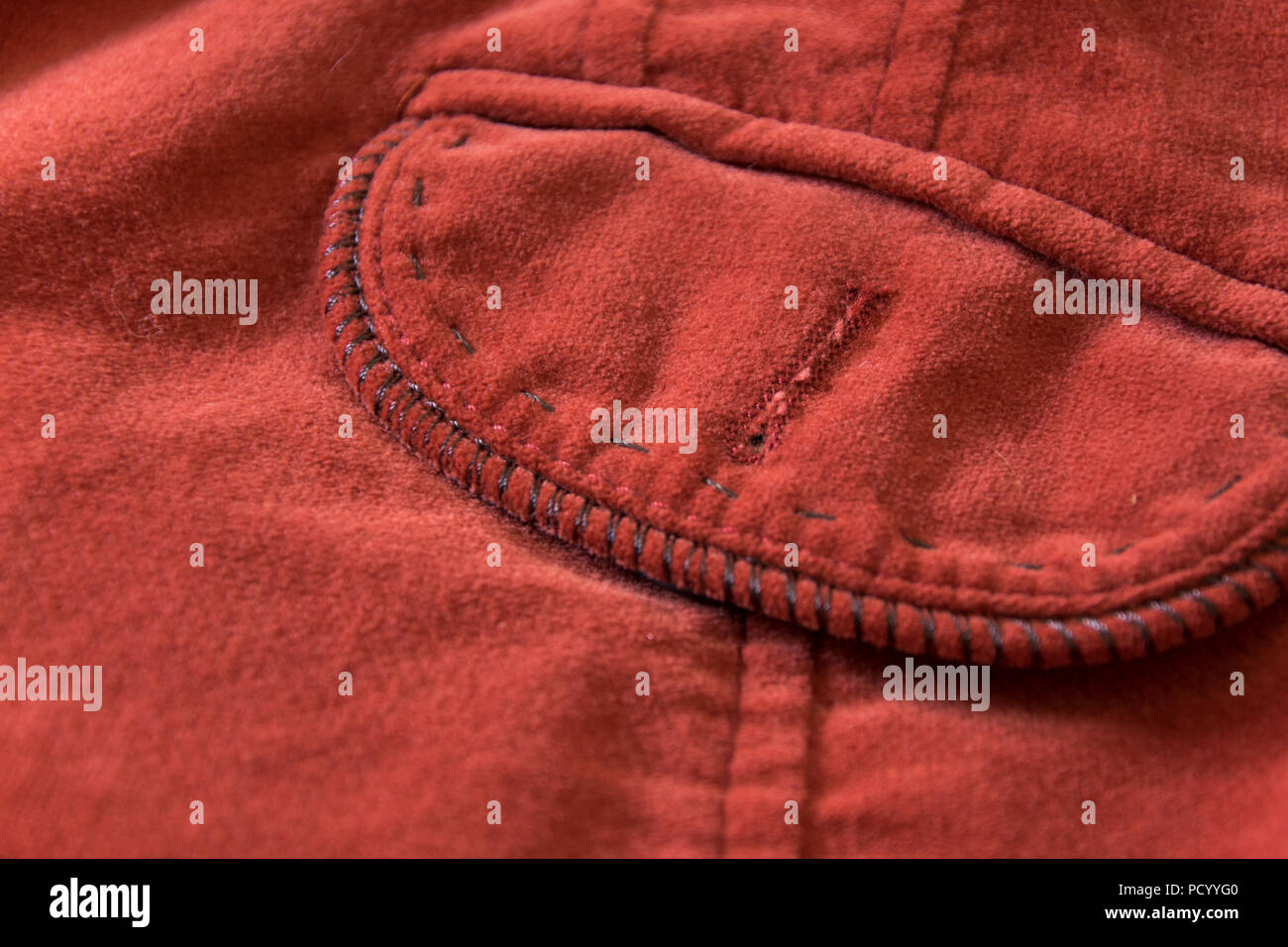 Close up view of pocket of old-fashioned red velvet jacket Stock Photo