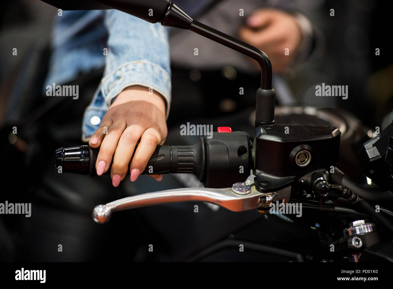 Woman's hand on a motorcycle handlebar Stock Photo