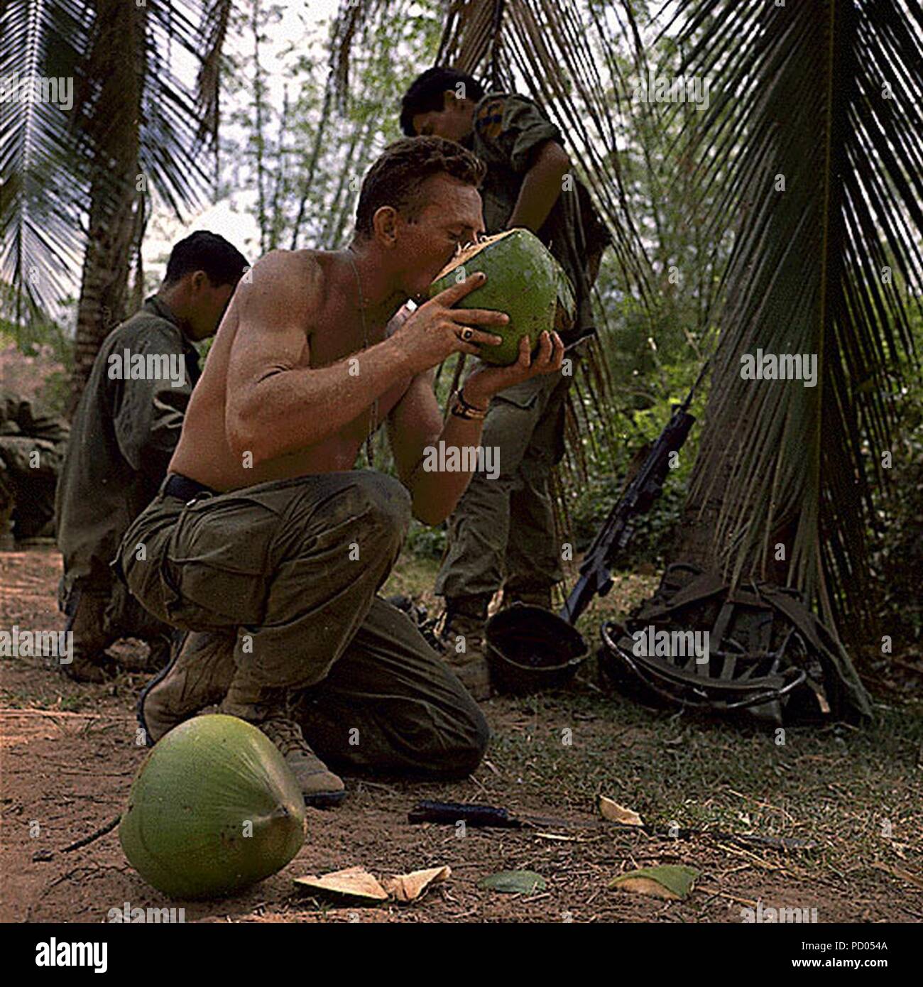 American-Soldier-Drinking-Coconut-Binh-Dinh-Vietnam-1968. Stock Photo