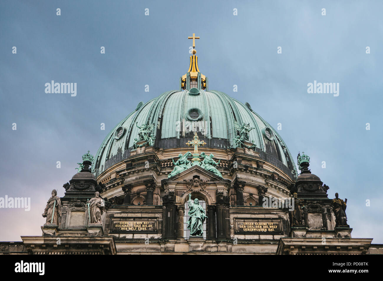 The Berlin Cathedral is called Berliner Dom against the backdrop of the setting sun. Beautiful old building in the style of neoclassicism and baroque with cross and sculptures. Berlin, Germany Stock Photo