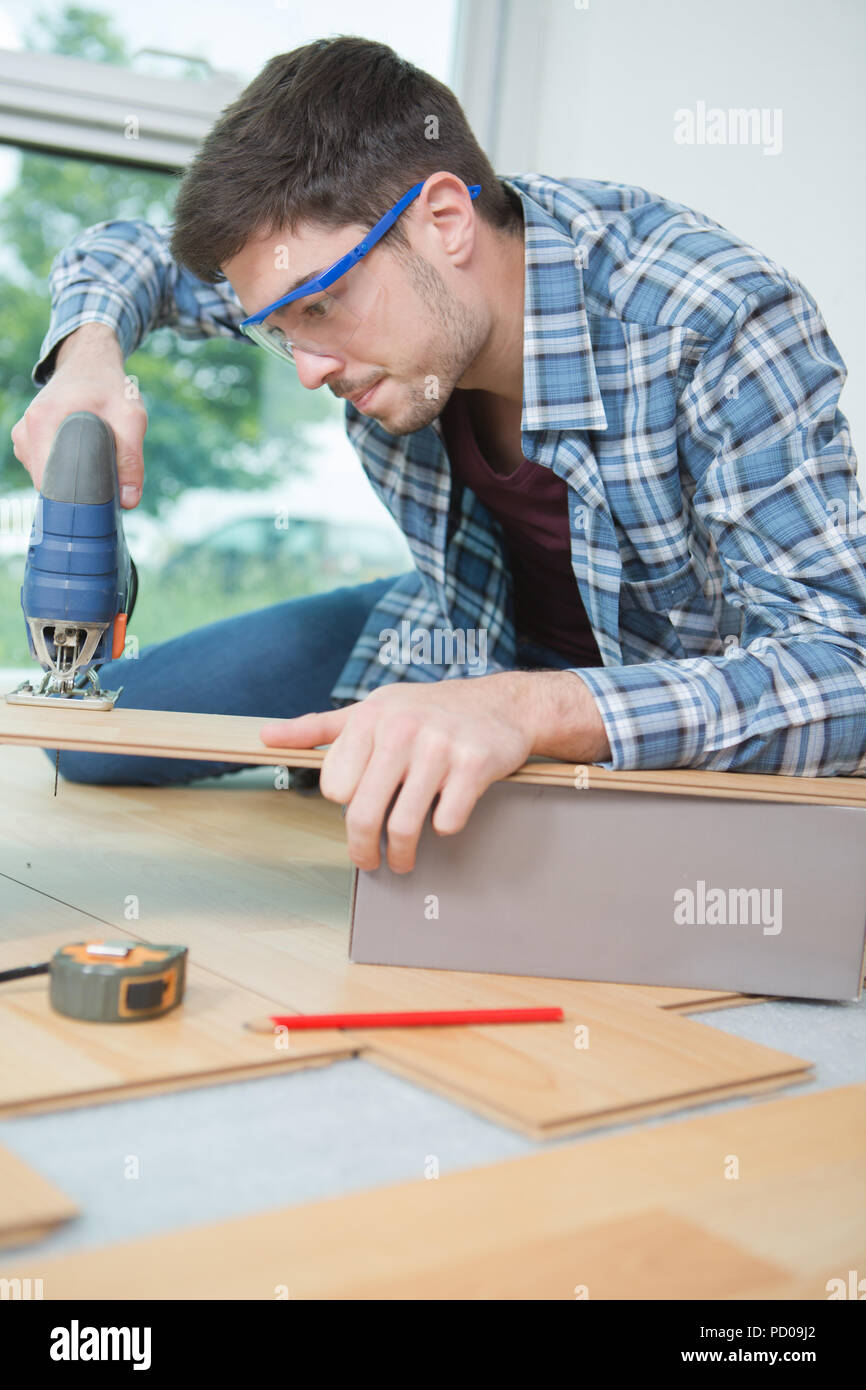 assembling furniture from chipboard using a cordless screwdriver Stock Photo