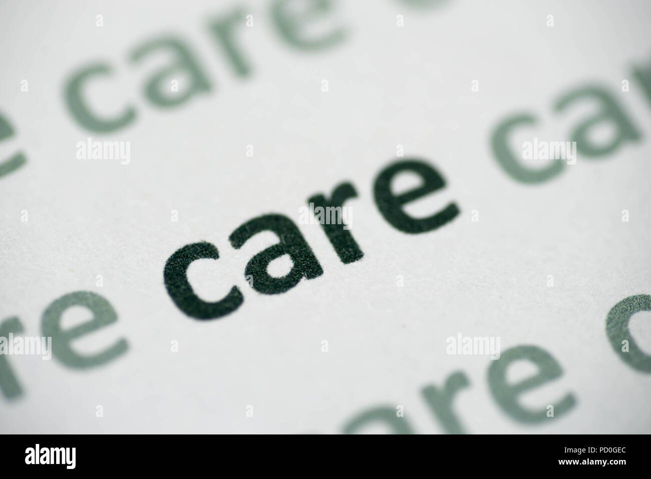 word care printed on white paper macro Stock Photo