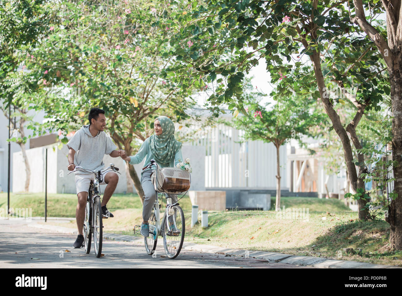 muslim couple riding a bike Stock Photo