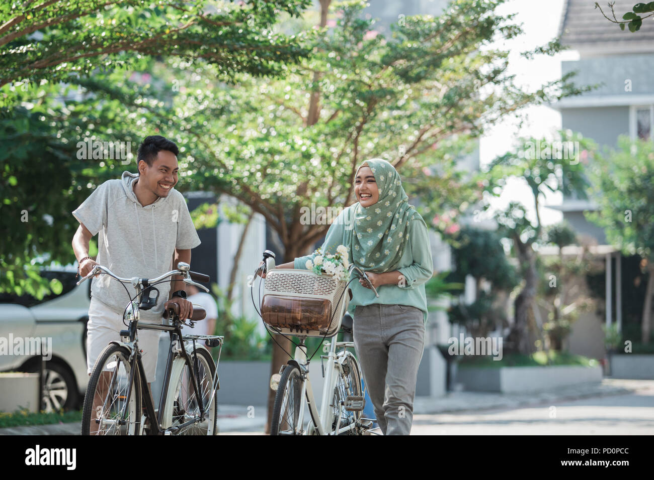 muslim couple riding a bike Stock Photo