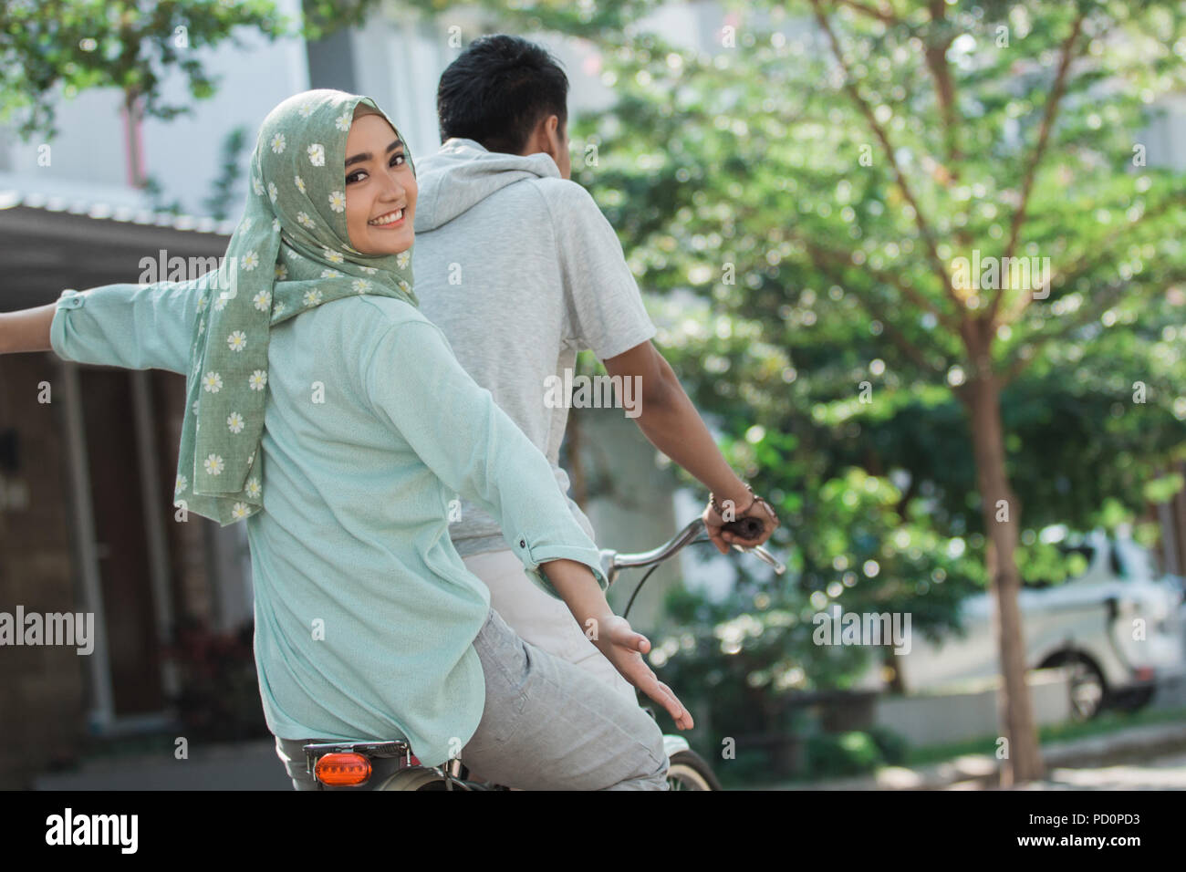 woman and man riding a bike Stock Photo