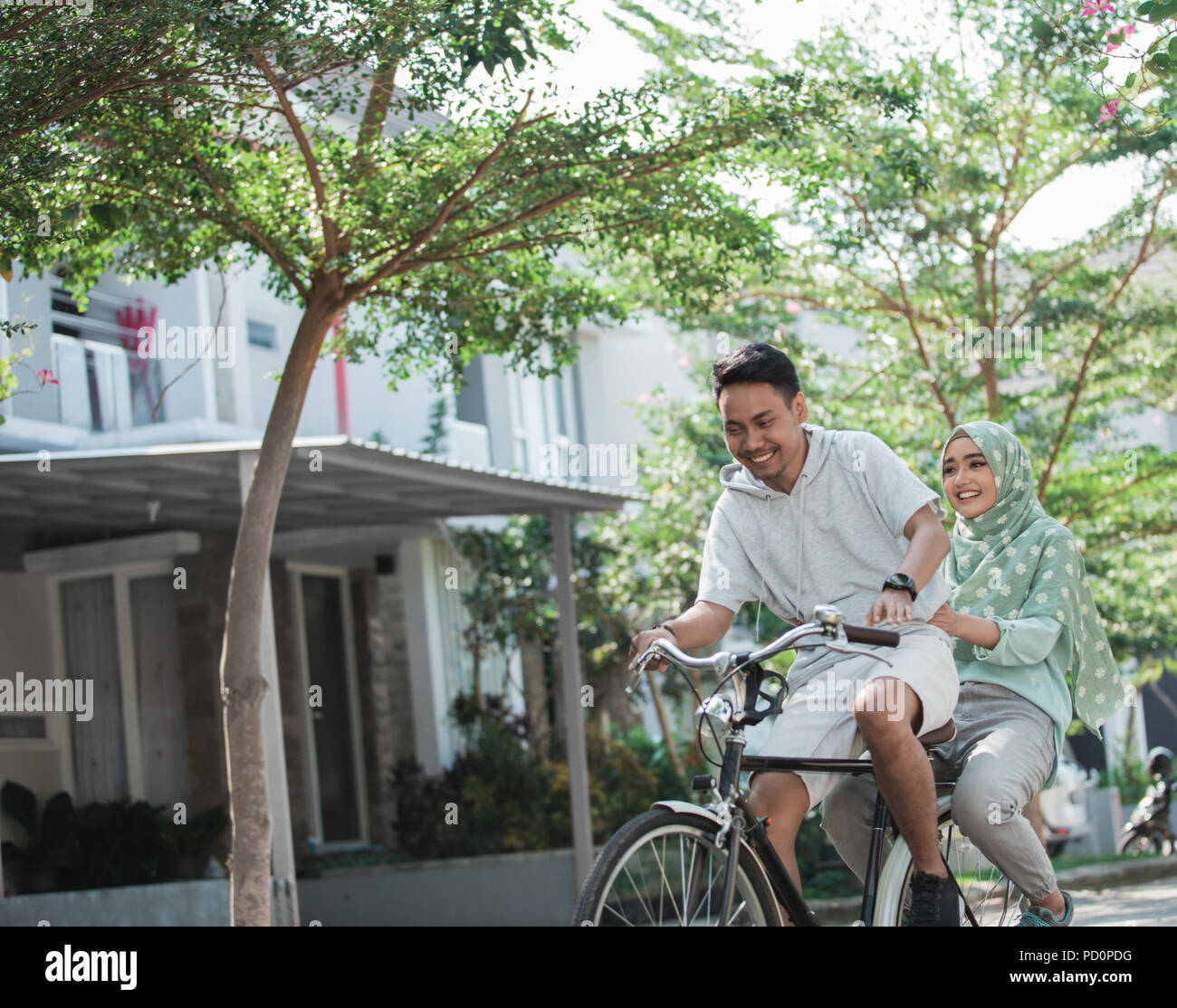 woman and man riding a bike Stock Photo