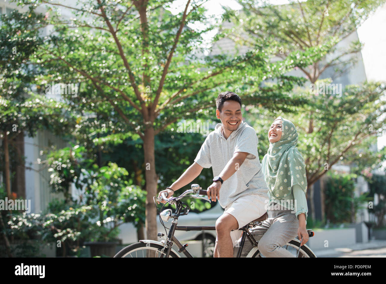 woman and man riding a bike Stock Photo