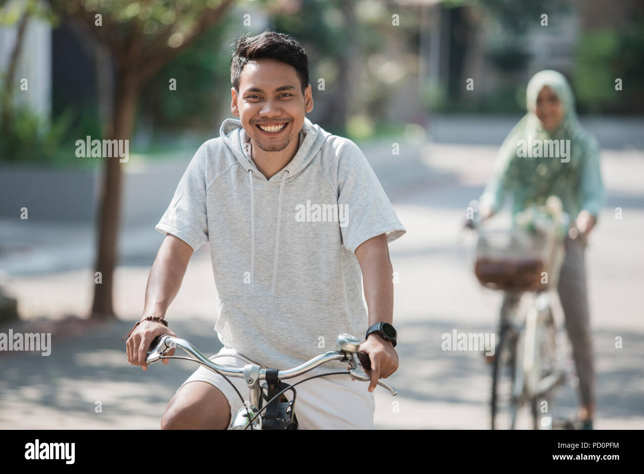 asian male riding a bike Stock Photo