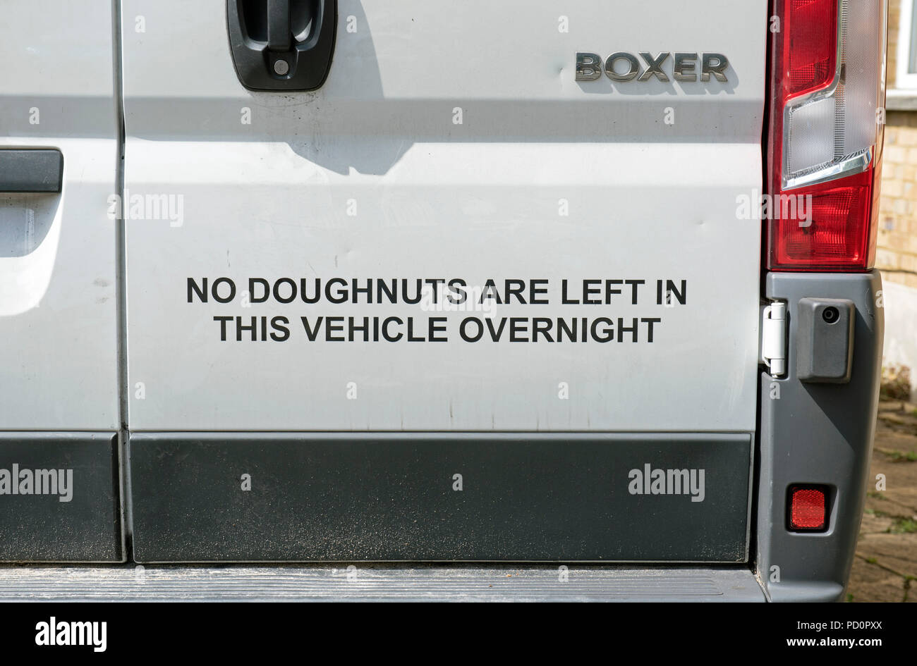 No Doughnuts are Left in this Vehicle Overnight - sign on back of bakers van. Stock Photo