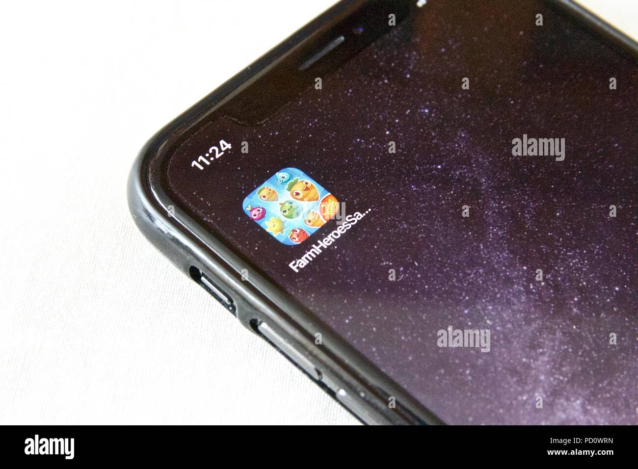 The app icon for Farm Heroes Saga, a farm themed match 3 puzzle game made by  King, on an iPhone X against a white background Stock Photo - Alamy