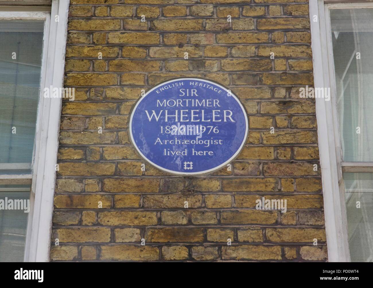 English heritage blue plaque on Whitcomb Street, London for Sir Mortmier Wheeler, an Archaeologist and officer in the British army Stock Photo