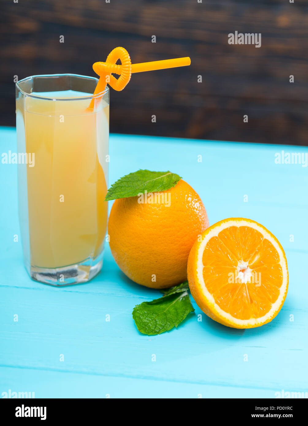 Healthy fresh orange juice rich in Vitamin C alongside a halved and