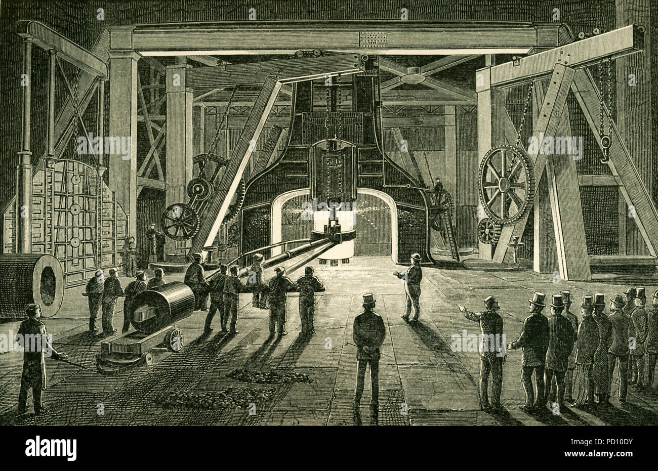 This illustration dates to the 1870s and shows the Great Steam Hammer Royal Gun Factory Woolwich. The hammer was, at the time, thought to be one of the most powerful steam hammers ever constructed. Its purpose was to forge great guns for the British Navy. The hammer was made by Nasymth & Co. Its height is about 50 feet and it is surrounded with furnaces and powerful cranes, carrying the huge iron tomgs that are to grap the glowing masses. Th hammer descend not merely with its own weight of 30 tons; steam is injected behind the falling piston, which is thus driven down with vastly enhanced rapi Stock Photo